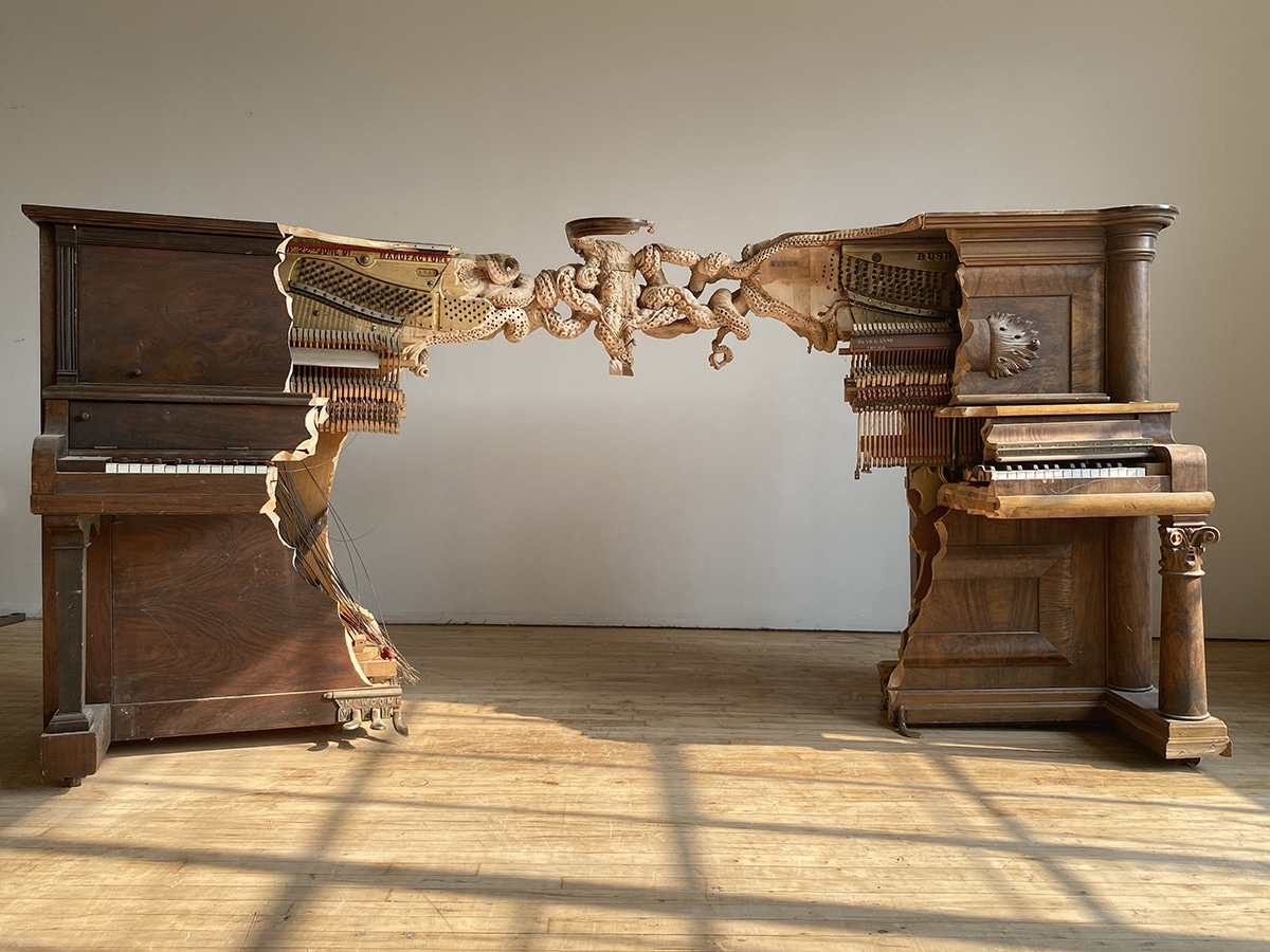 Realistically carved octopus joins together two pianos to form one surreal sculpture